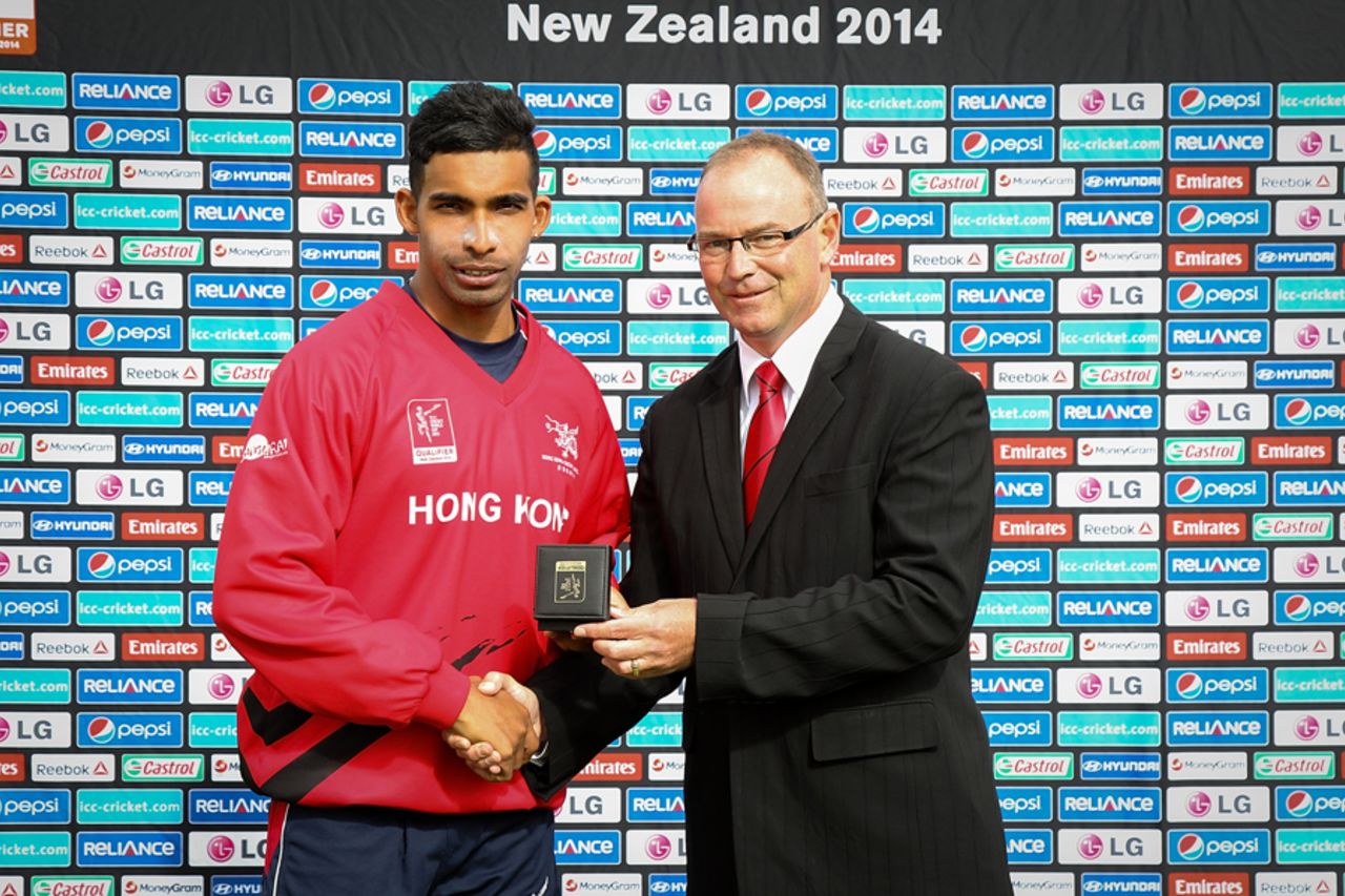 Irfan Ahmed of Hong Kong is awarded man of the match from Lee Germon of Canterbury Cricket after the ICC Cricket World Cup Qualifier Semi Final match between Papua New Guinea and Hong Kong at Bert Sutcliffe Oval on January 30, 2014 in Lincoln, New Zealand.