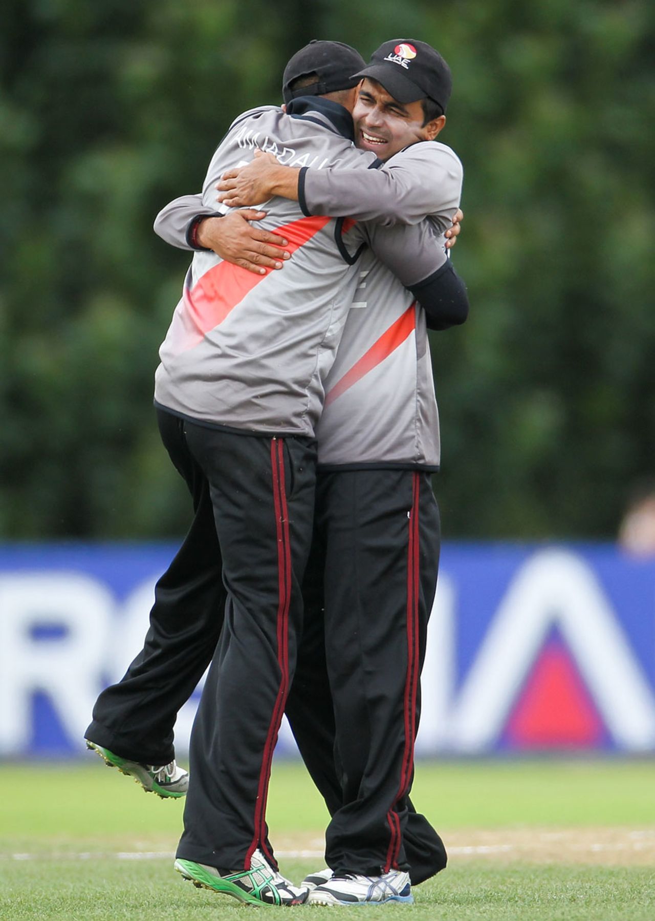 Amjad Ali is hugged by his captain Khurram Khan after taking a catch, Cricket World Cup Qualifier, final, Lincoln, February 1, 2014