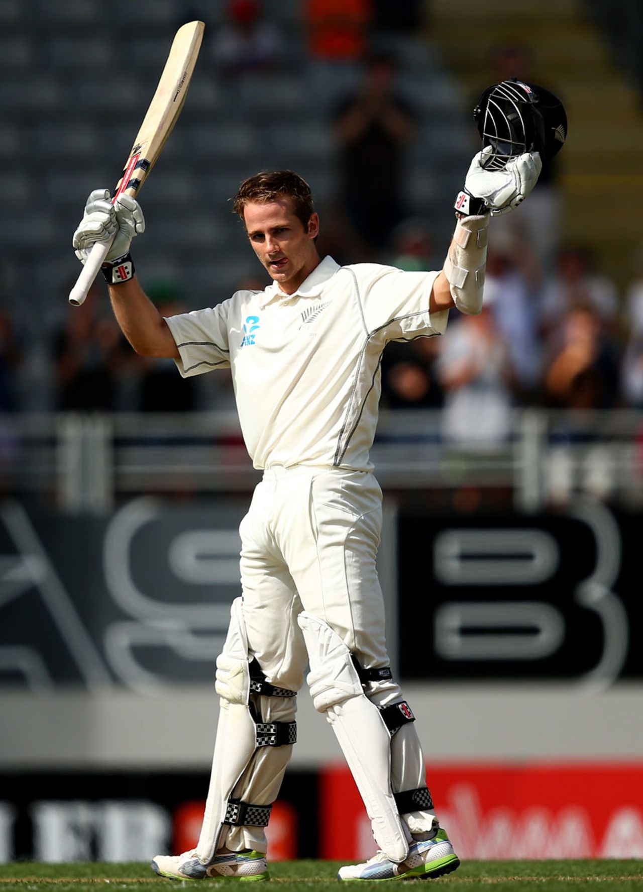 Kane Williamson raises the bat after reaching his hundred, New Zealand v India, 1st Test, Auckland, 1st day, February 6, 2014