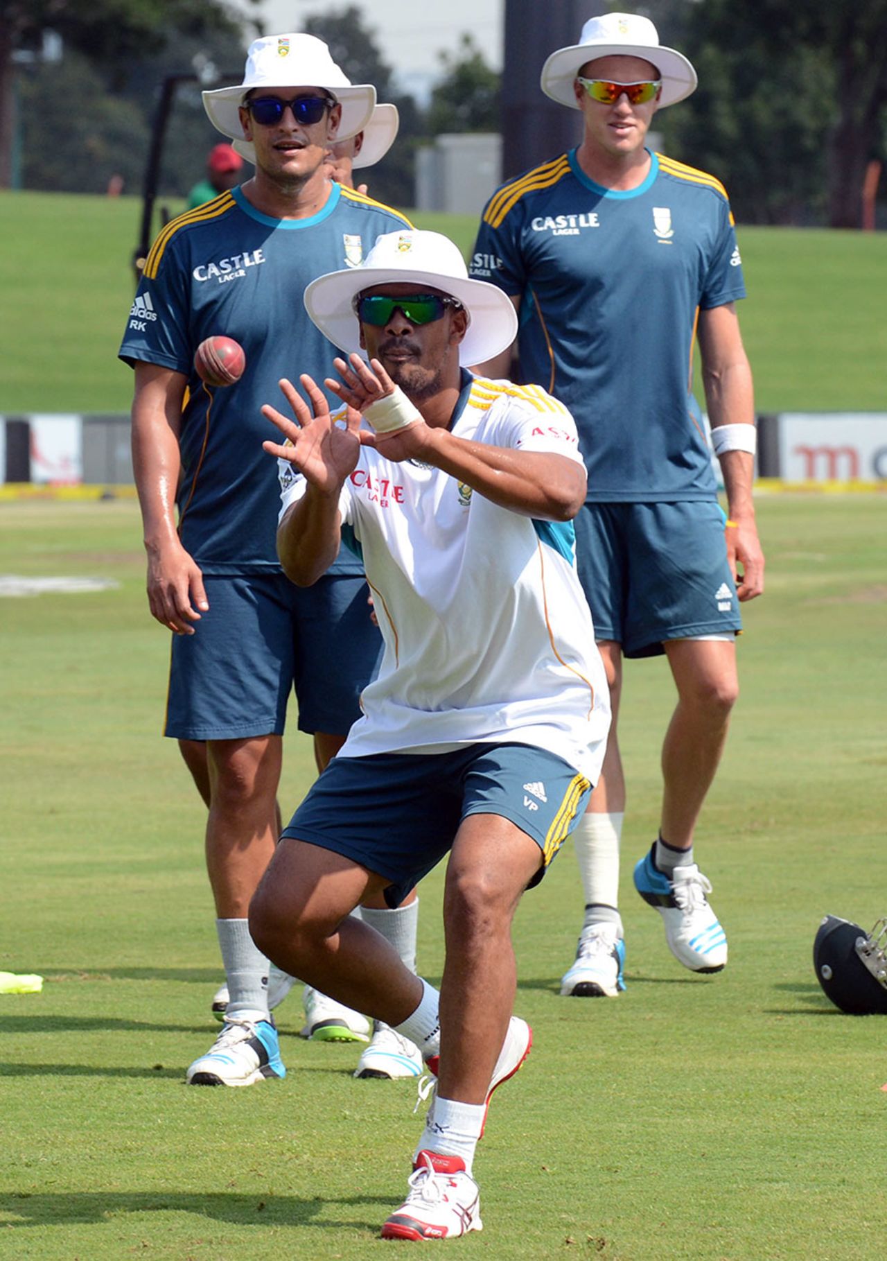 Vernon Philander takes a catch as Faf du Plessis and Morne Morkel wait their turn, Centurion, February 10, 2014