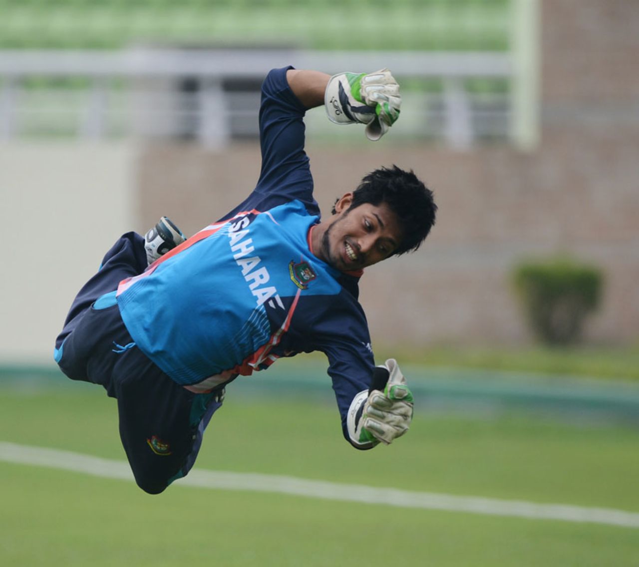 Anamul Haque attempts a diving catch during a training session, Dhaka, February 16, 2014