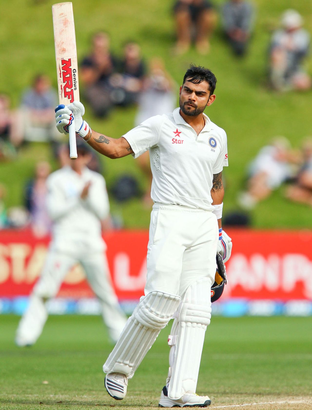 Virat Kohli raises the bat after reaching his hundred, New Zealand v India, 2nd Test, Wellington, 5th day, February 18, 2014