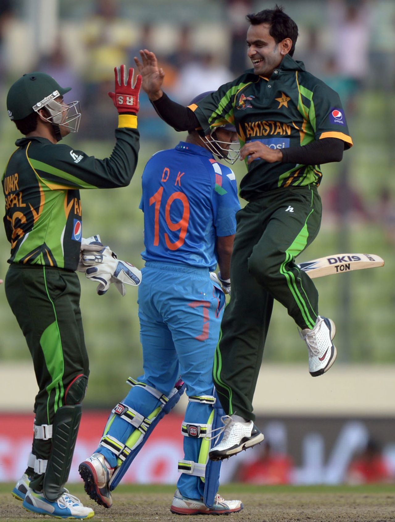 Mohammad Hafeez leaps in joy after dismissing Dinesh Karthik, India v Pakistan, Asia Cup, Mirpur, March 2, 2014