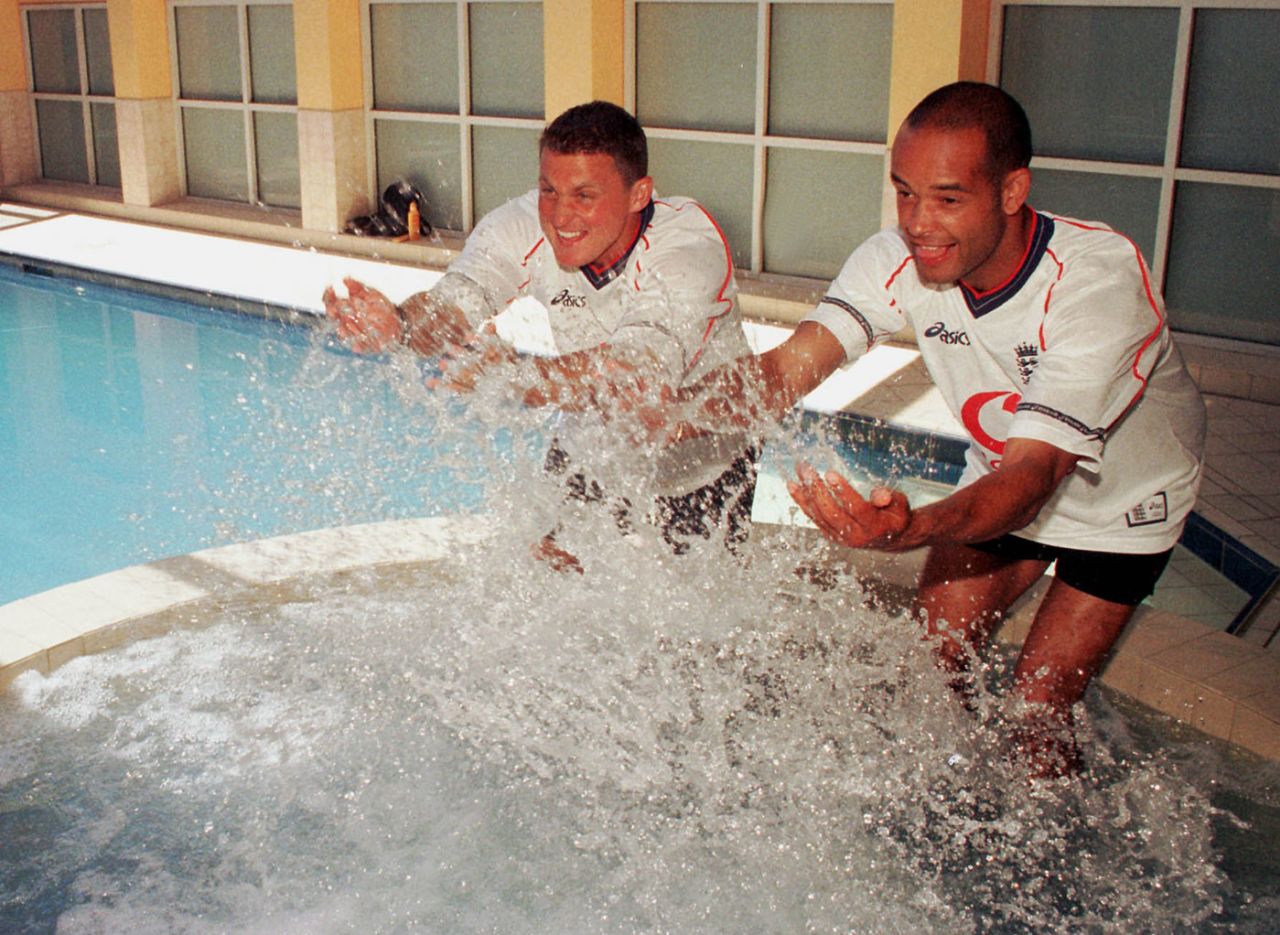 Darren Gough and Dean Headley splash water on photographers at the team hotel after England's win in Melbourne, December 30, 1998