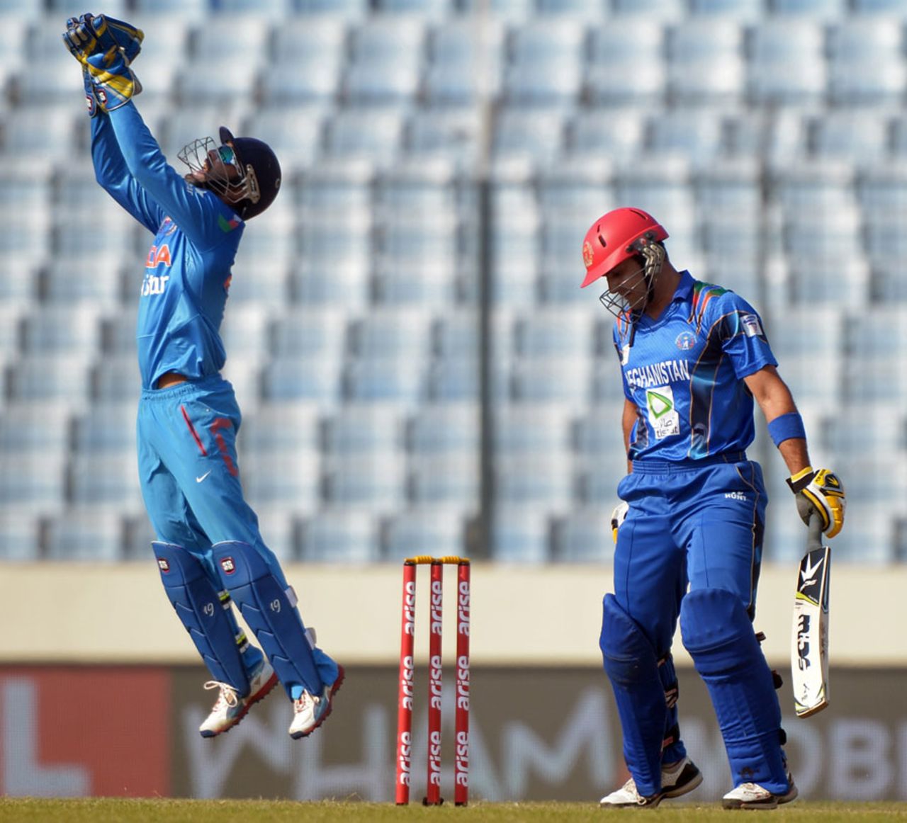 Dinesh Karthik celebrates the wicket of Mohammad Nabi, Afghanistan v India, Asia Cup, Mirpur, March 5, 2014