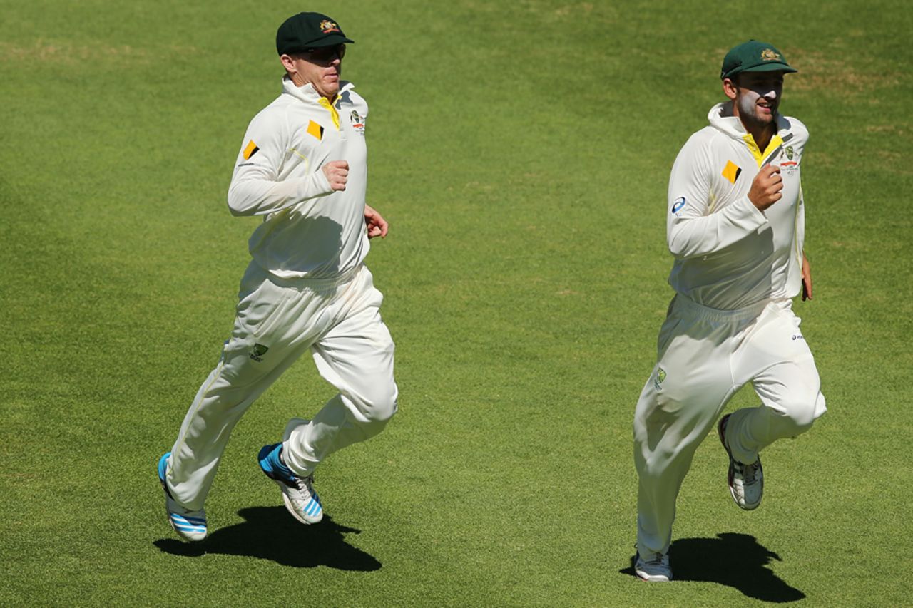 Chris Rogers and Nathan Lyon chase the ball, South Africa v Australia, 3rd Test, Cape Town, 5th day, March 5, 2014