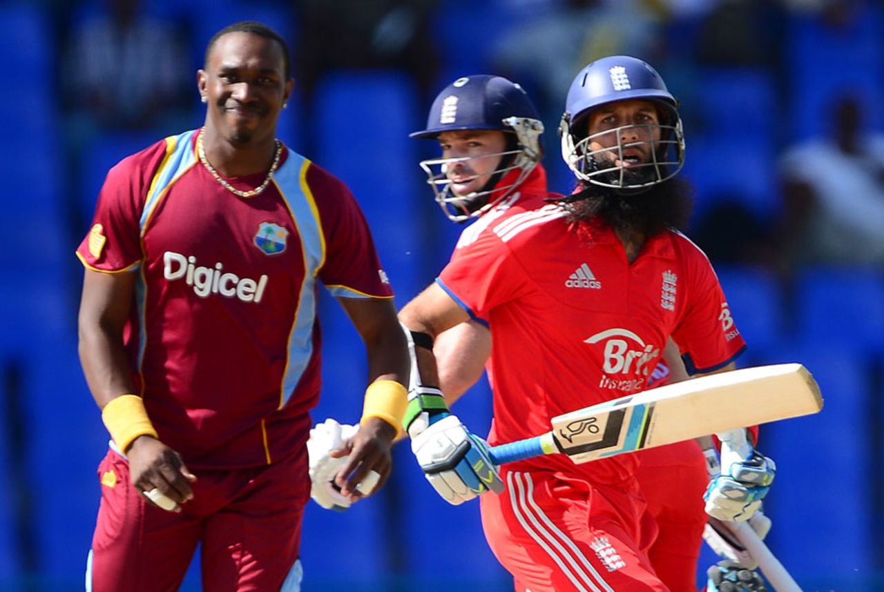 Dwayne Bravo looks on as Moeen Ali and Michael Lumb cross, West Indies v England, 3rd ODI, Antigua, March 5, 2014