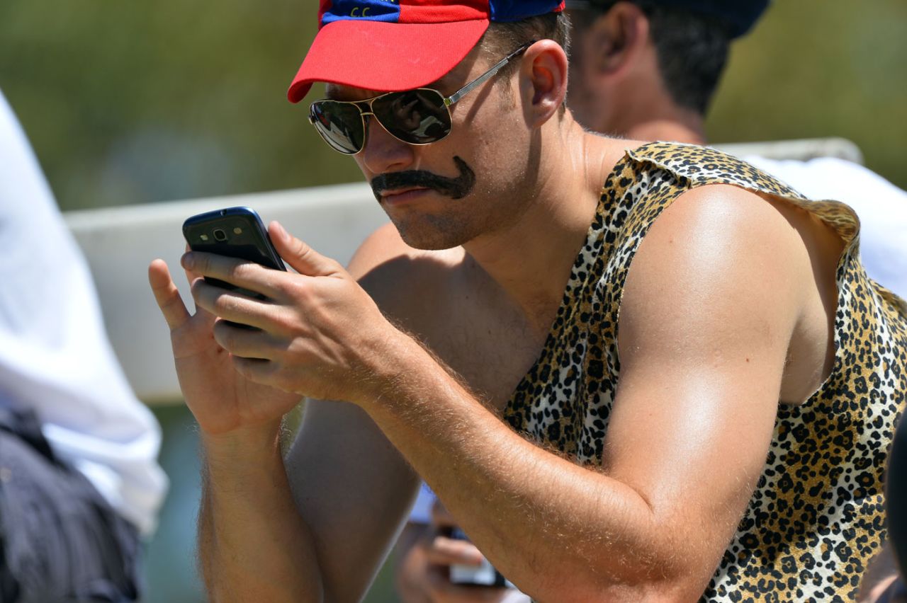 A fan looks at his phone, CA Chairman's XI v England XI, Tour match, Alice Springs, November 29, 2013