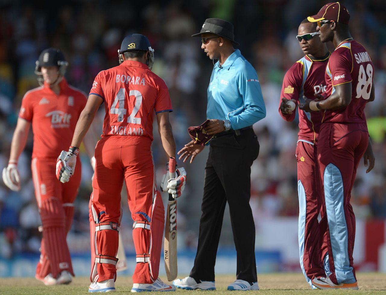 The umpire intervenes to break-up an argument between players, West Indies v England, 1st T20, Barbados, March 9, 2014