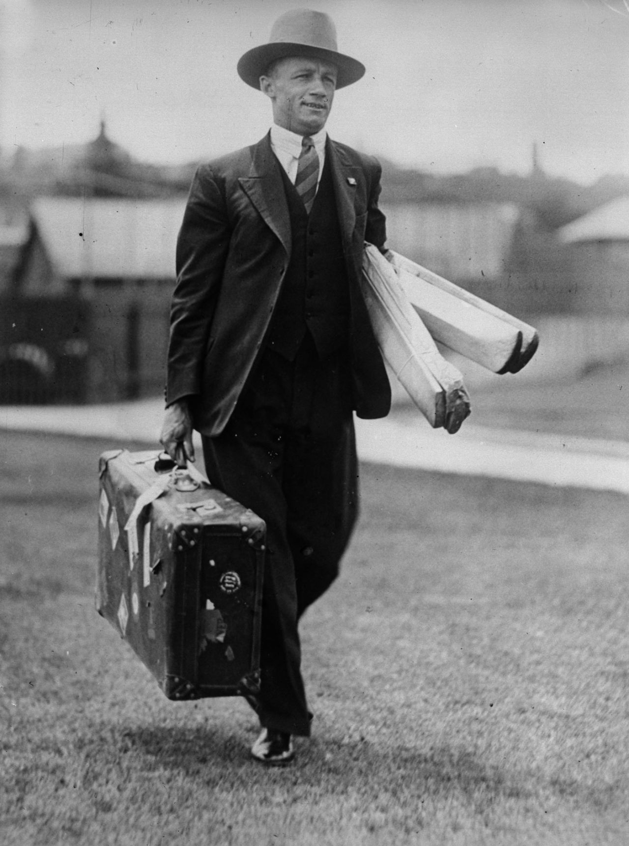 Don Bradman carries his bats and a suitcase to a match, 1932