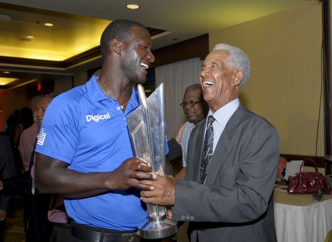 Darren Sammy and Garry Sobers share a light moment with the World T20 trophy, Bridgetown, March 13, 2014