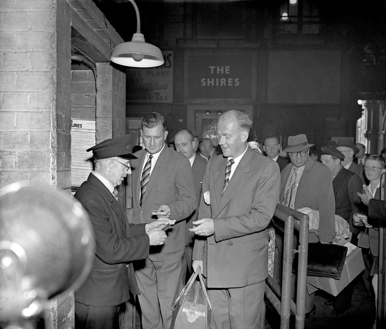 Jim Laker and Tony Lock have their tickets inspected before they board a train at St Pancras station on their way to Australia, September 14, 1958