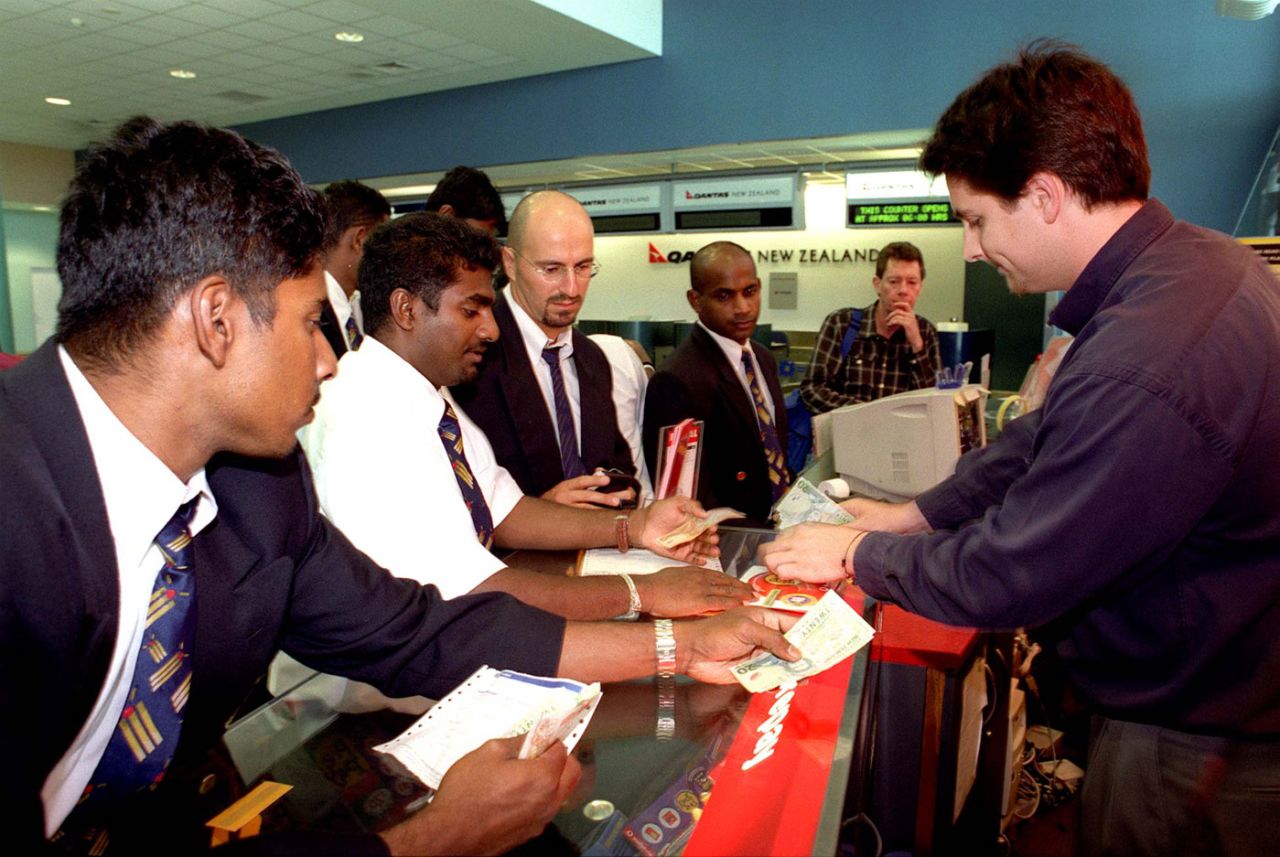 Muttiah Muralittharan, Chaminda Vaas and Sanath Jayasuriya buy phone cards at Auckland airport buy phone cards at Auckland airport, Auckland, January 27, 2001