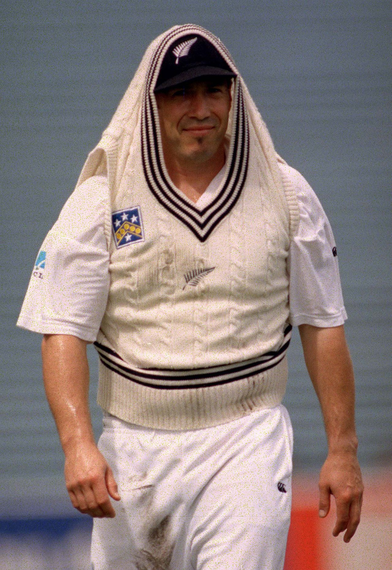 Roger Twose takes cover during a rain interruption, New Zealand v South Africa, 1st Test, Auckland, 1st, February 27, 1999