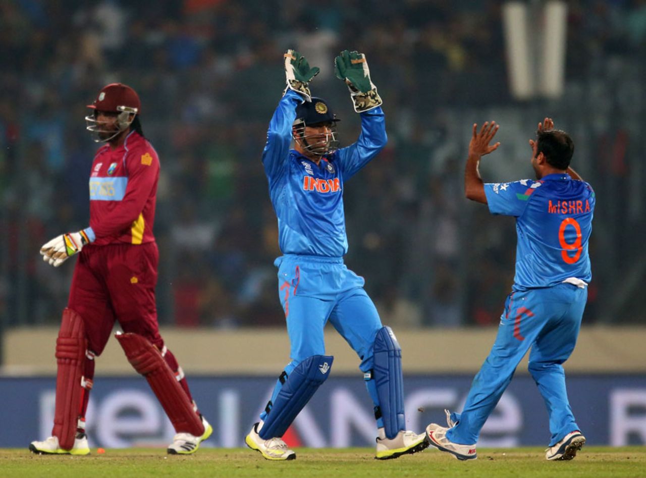 MS Dhoni and Amit Mishra celebrate the run-out of Chris Gayle, India v West Indies, World T20, Group 2, Mirpur, March 23, 2014
