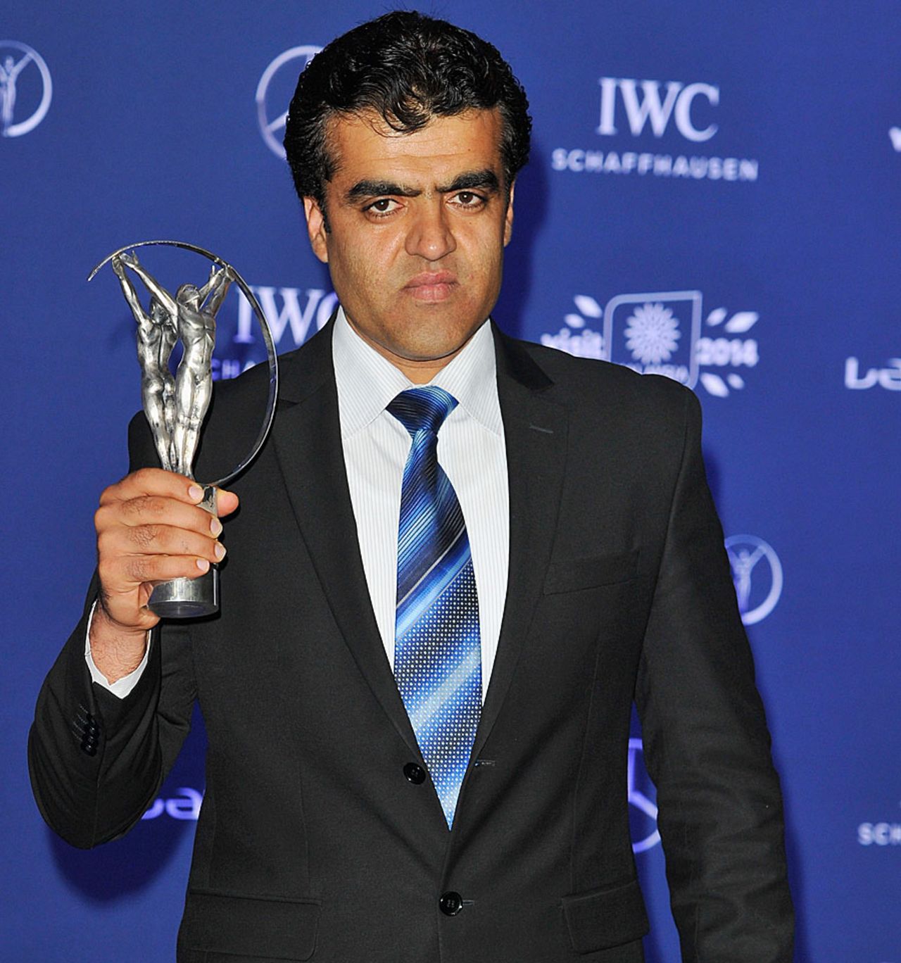 Afghanistan Cricket Board CEO Noor Mohammad Murad poses with the Laureus award, Kuala Lumpur, March 26, 2014
