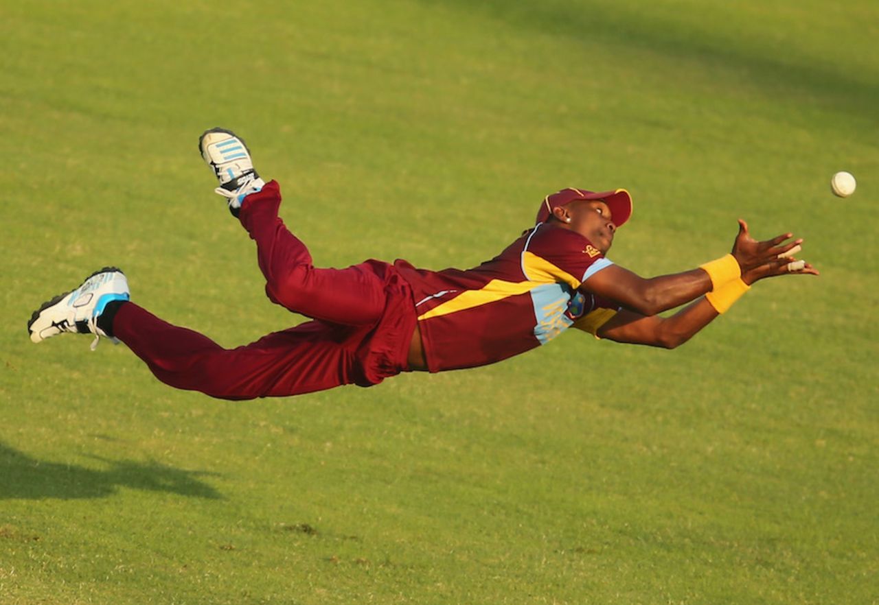 Dwayne Bravo has his eyes firmly on the ball as he goes for the catch, Australia v West Indies, World T20, Group 2, Mirpur, March 28, 2014
