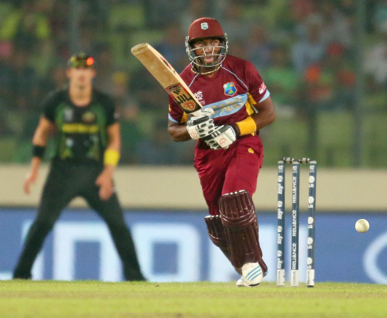 Dwayne Bravo follows through after playing the ball on to the leg side, Australia v West Indies, World T20, Group 2, Mirpur, March 28, 2014