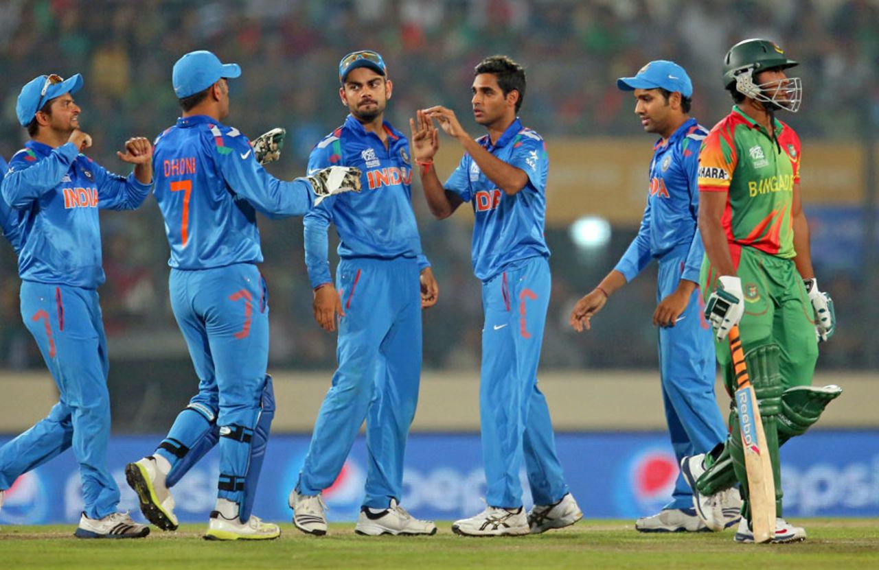 Team-mates congratulate Bhuvneshwar Kumar after Shakib Al Hasan's wicket, Bangladesh v India, World T20, Group 2, Mirpur, March 28, 2014