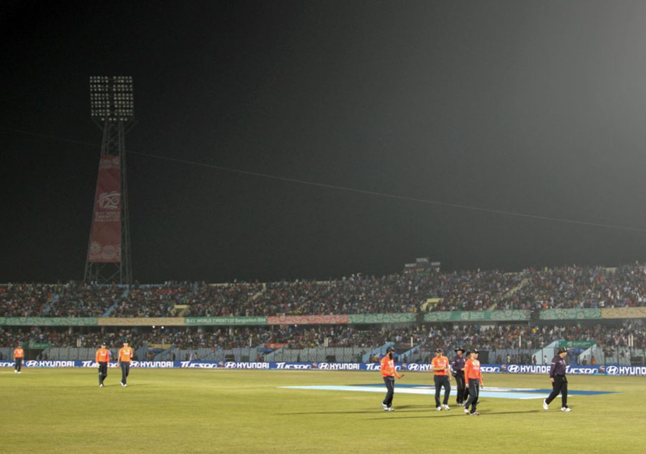 Players walk off the field after one of the light towers suffers an outage, England v South Africa, World Twenty20 2014, Group 1, Chittagong, March 29, 2014