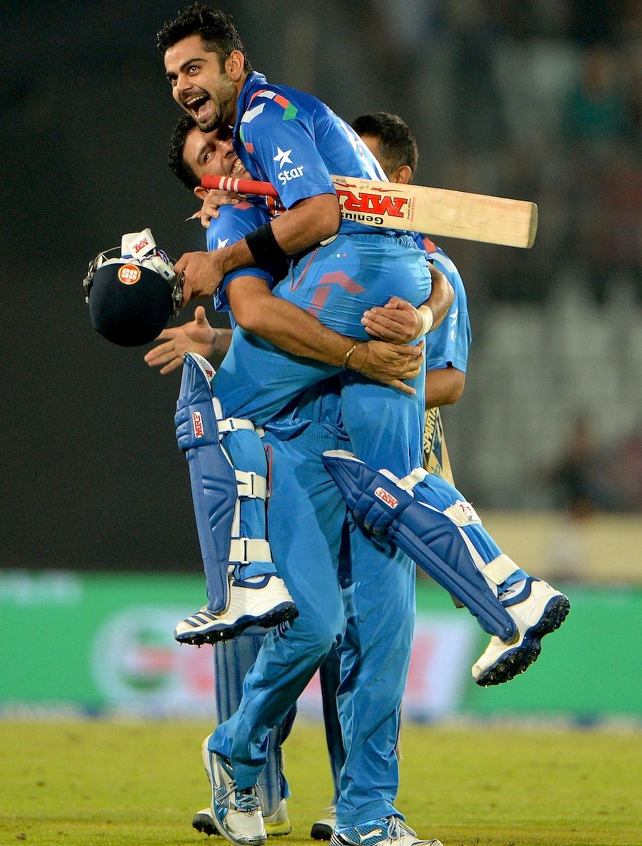 Yuvraj Singh lifts Virat Kohli up after the win, India v South Africa, World T20, semi-final, Mirpur, April 4, 2014