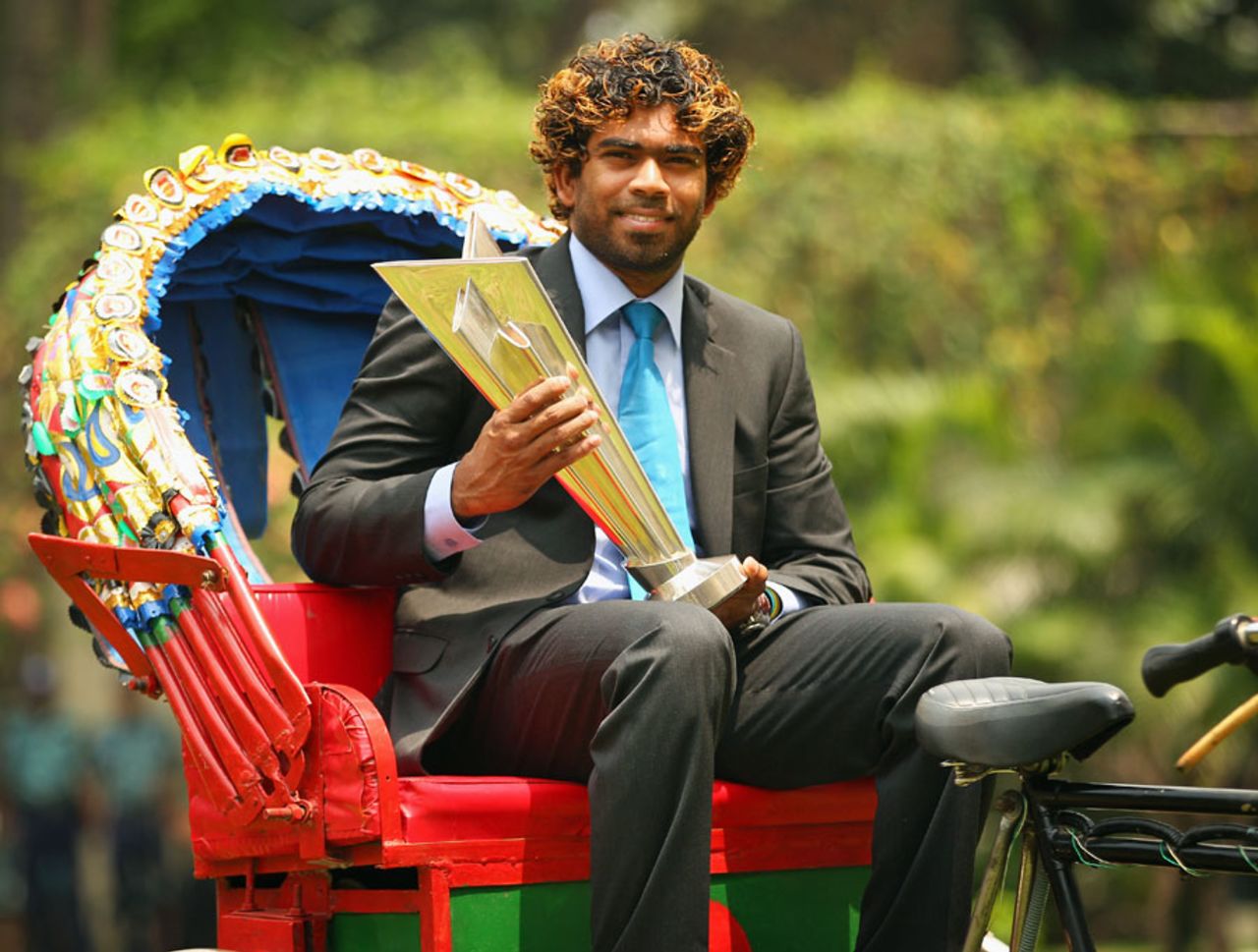 Lasith Malinga is perched atop a cycle rickshaw with the World T20 trophy, Dhaka, April 7, 2014