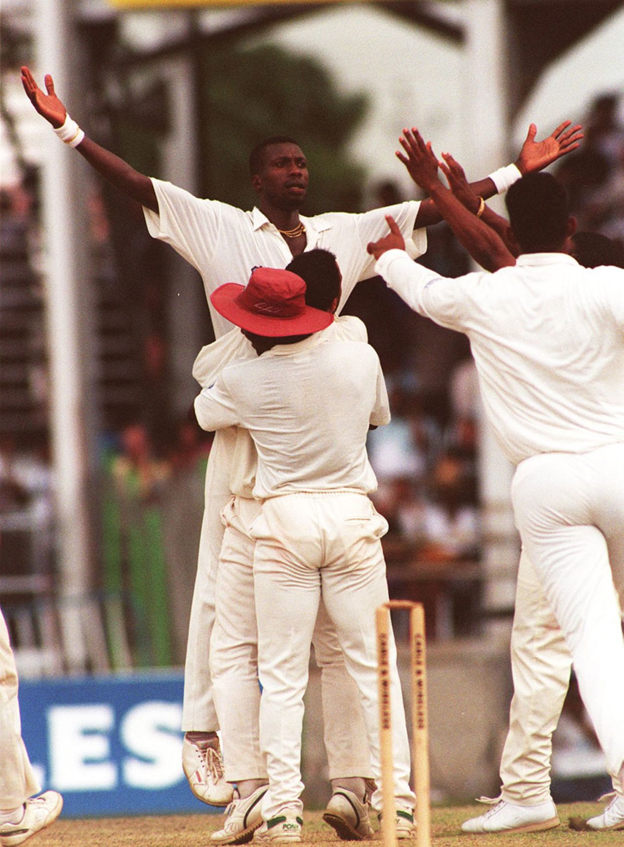 Curtly Ambrose's team-mates rush to congratulate him, West Indies v England, 3rd Test, Trinidad, 4th day, March 29, 1994
