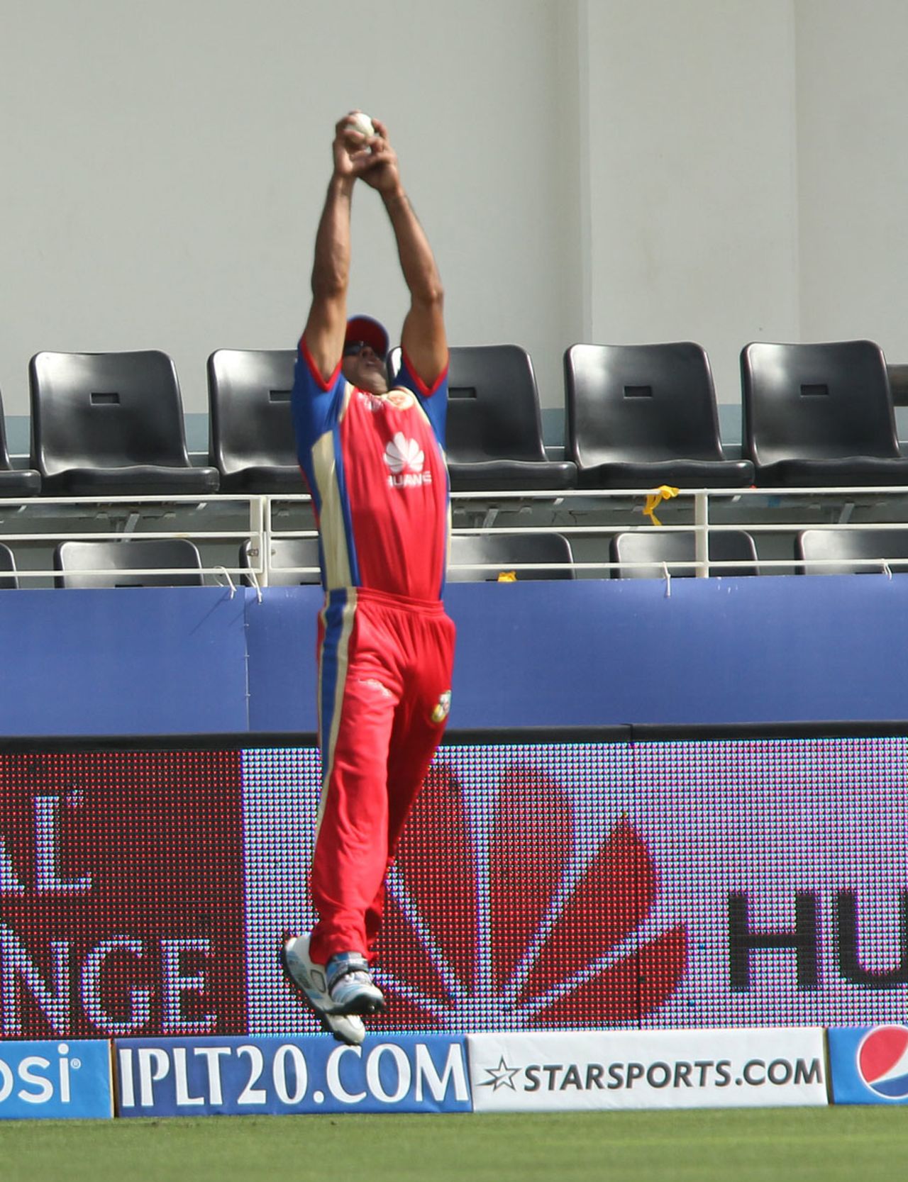 Sachin Rana times his leap to perfection to take the catch of Kieron Pollard, Royal Challengers Bangalore v Mumbai Indians, Indian Premier League, Dubai, April 19, 2014