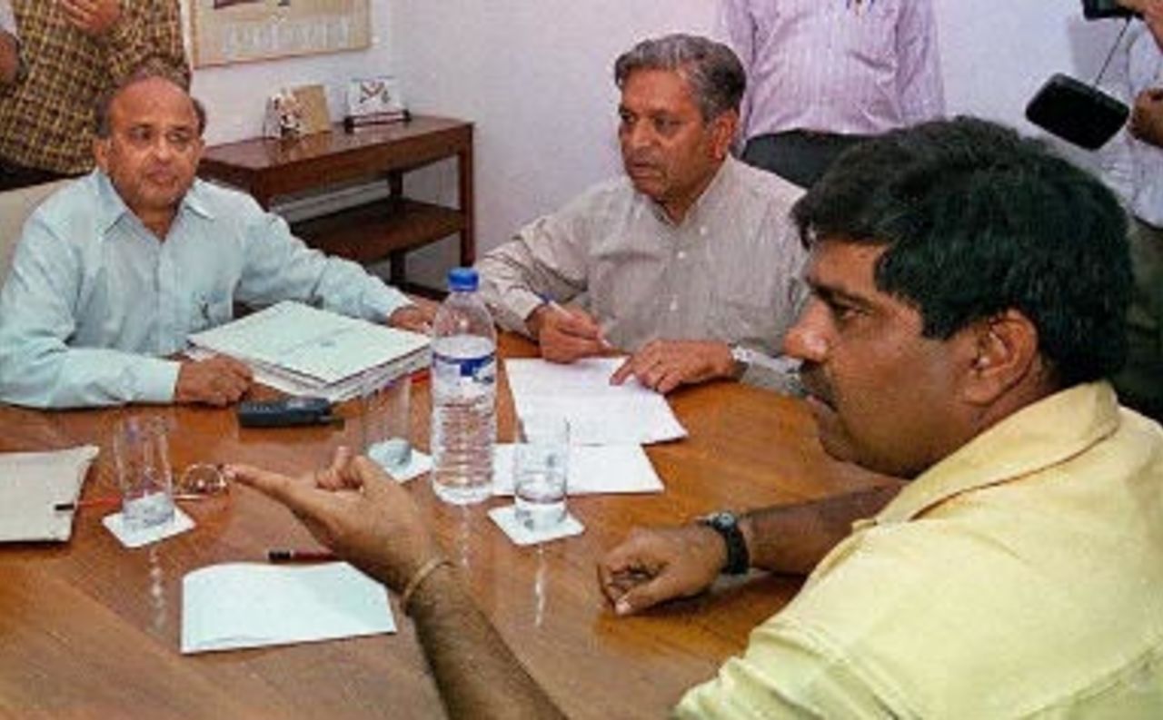 Members of the Board of Control for Cricket in India (BCCI), secretary Jayant Lele (L) and board president Chandu Borde (C), watch selector Anil Malhotra make his point during a meeting at the Cricket Club of South Mumbai 05 May 2000 to select the Indian cricket team for the forthcoming four-nations cricket tournament to be played in Dhaka. The Indian cricket team has been rocked by allegations of match-fixing with team-coach and former player Kapil Dev being accused of having offered a bribe to then teammate Manoj Prabhakar during their playing days.