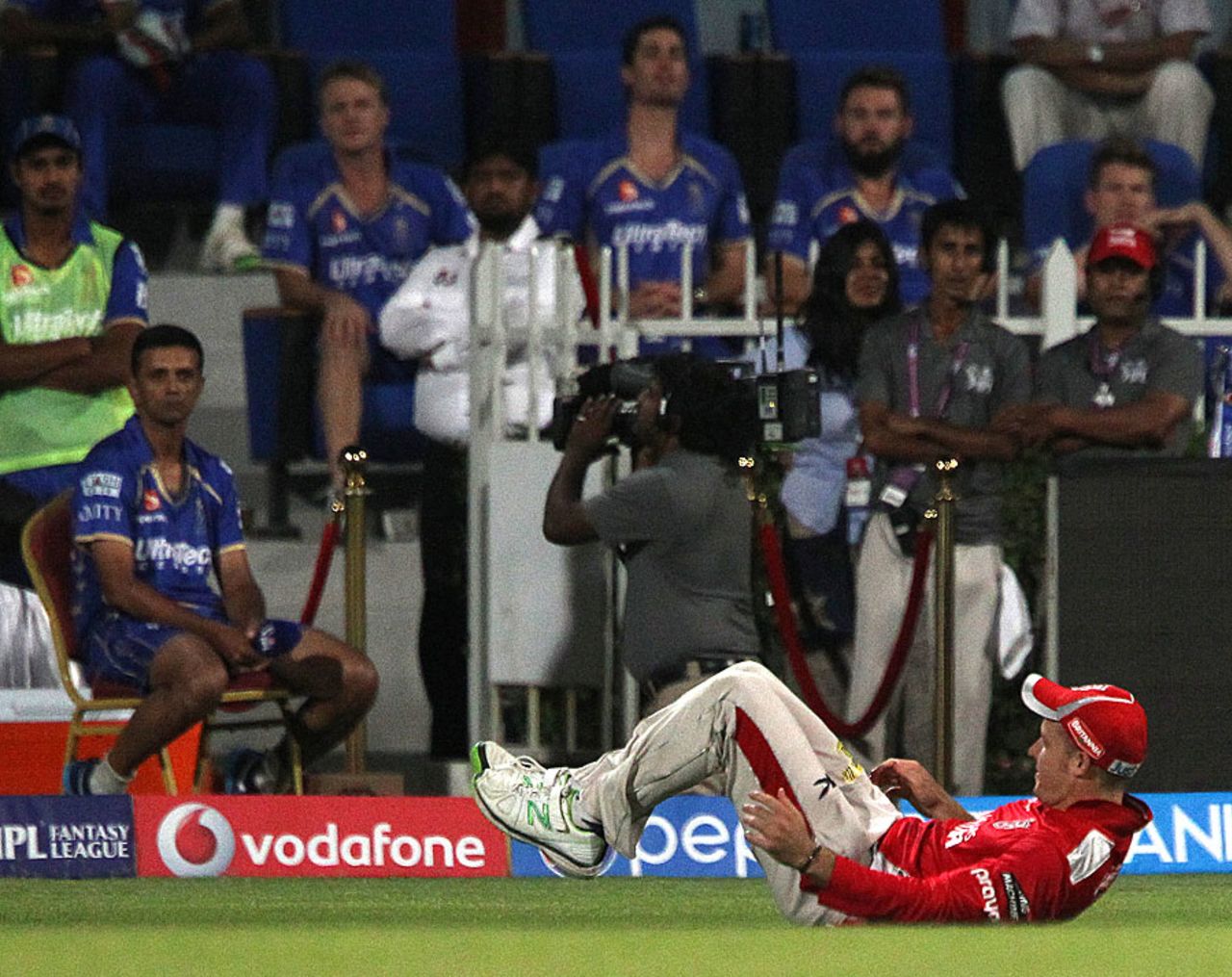 The ball is wedged between David Miller's legs after the ball slipped through his fingers, Rajasthan Royals v Kings XI Punjab, IPL 2014, Sharjah, April 20, 2014