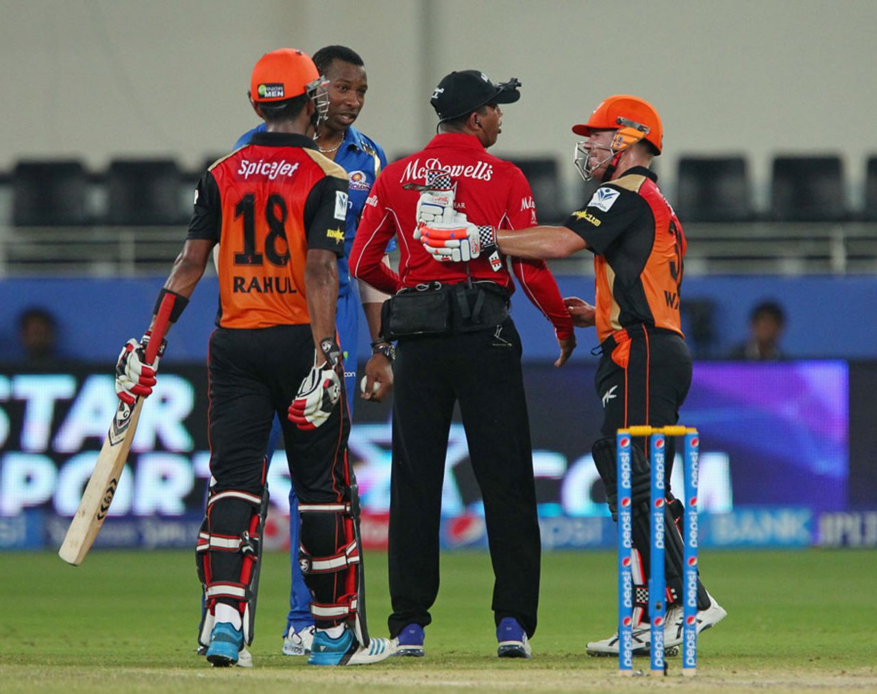David Warner checks on umpire Kumar Dharmasena after the latter was hit by a ball, Mumbai Indians v Sunrisers Hyderabad, IPL 2014, Dubai, April 30, 2014