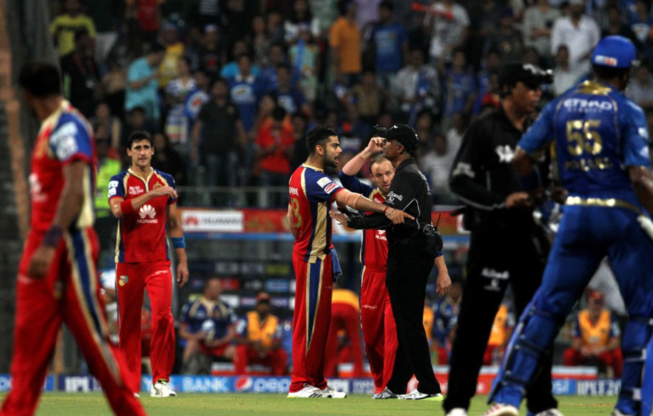 The umpires try to regain control after the Kieron Pollard-Mitchell Starc altercation, Mumbai Indians v Royal Challengers Bangalore, IPL 2014, Mumbai, May 6, 2014