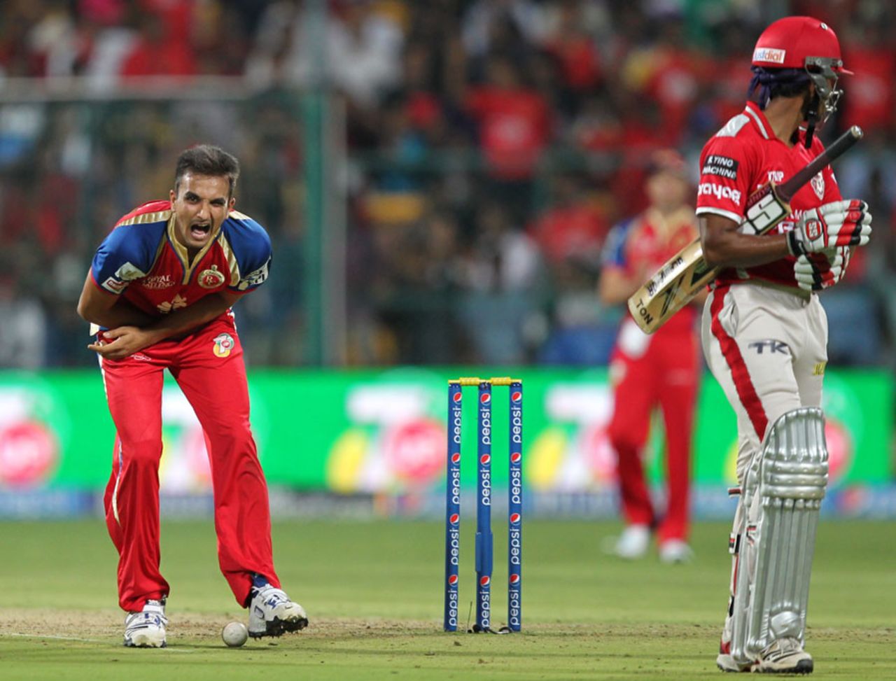 Harshal Patel grimaces after being hit by a throw from AB de Villiers, Royal Challengers Bangalore v Kings XI Punjab, IPL 2014, Bangalore, May 9 2014