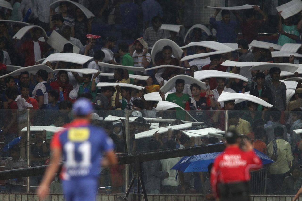 Spectators take cover from the rain, Delhi Daredevils v Sunrisers Hyderabad, IPL 2014, Delhi, May 10, 2014