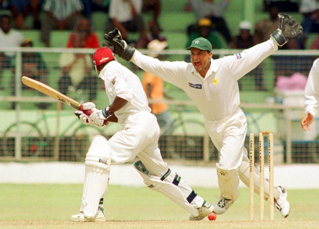 West Indies opening batsman Sherwin Campbell (L) was bowled out by Pakistani Saqlain Mushtaq as Pakistani wicket  keeper Moin Khan (R) celebrates on the second day of the second Cable & Wireless Test at Kensington Oval, in the Barbados, 19 May 2000. Pakistan in West Indies, West Indies v Pakistan  (18-22 May 2000)