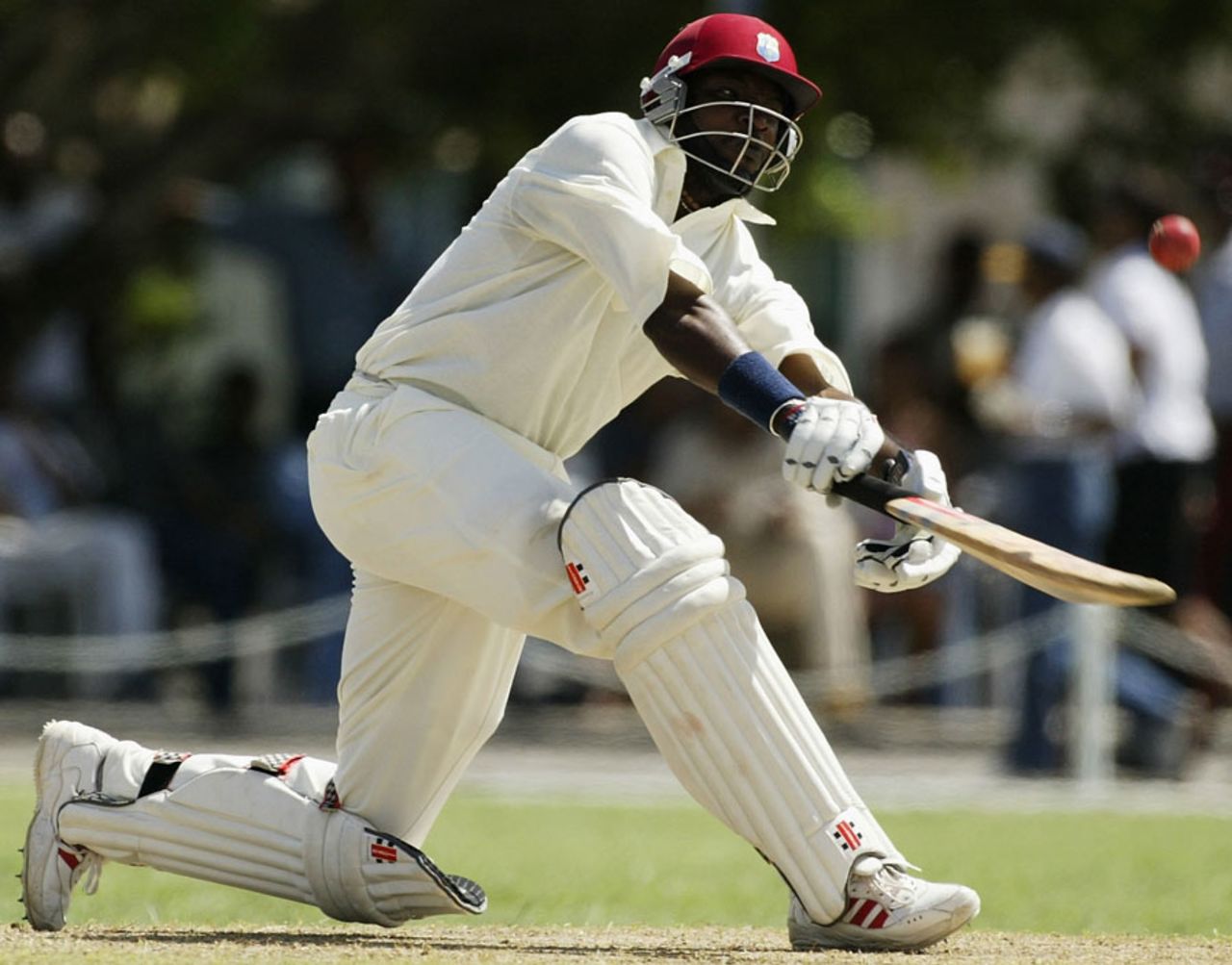 Chris Gayle attempts a sweepshot, University XI v Australians, April 26, 2003