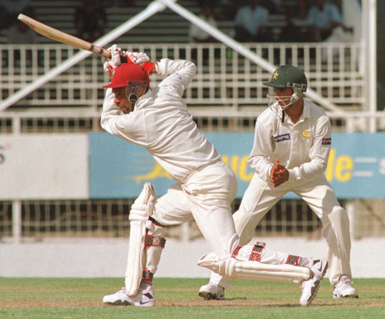 West Indies Captain Jimmy Adams (L) drives the ball in his undefeated half century 26 May, 2000, during the second day of the third and deciding test against Pakistan. Pakistan in West Indies 1999/00, 3rd Test, West Indies v Pakistan, Antigua Recreation  Ground, St John's, Antigua, (25-29 May 2000) Day 2.