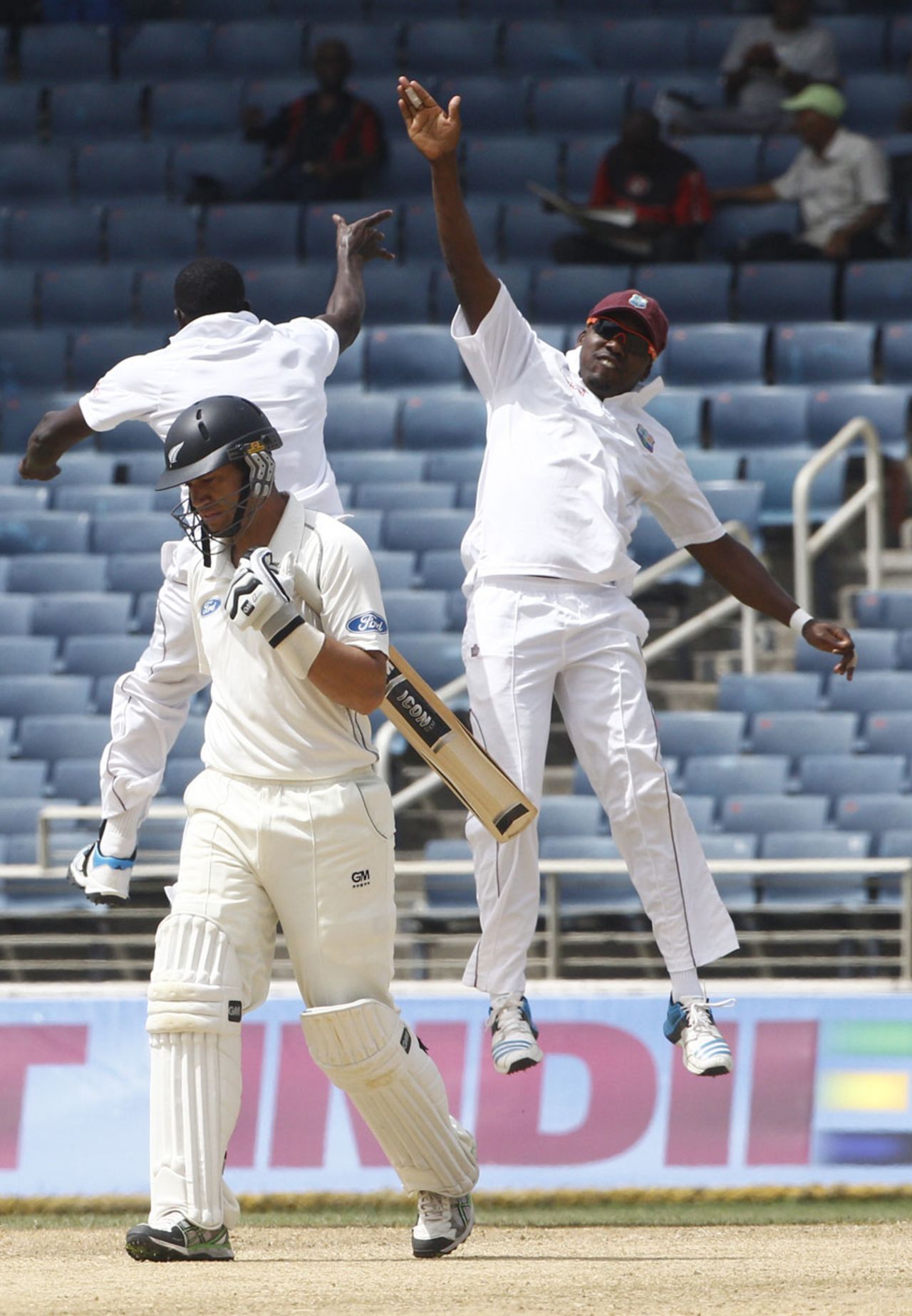 Jerome Taylor and Darren Bravo celebrate the wicket of Ross Taylor, West Indies v New Zealand, 1st Test, Kingston, 4th day, June 11, 2014