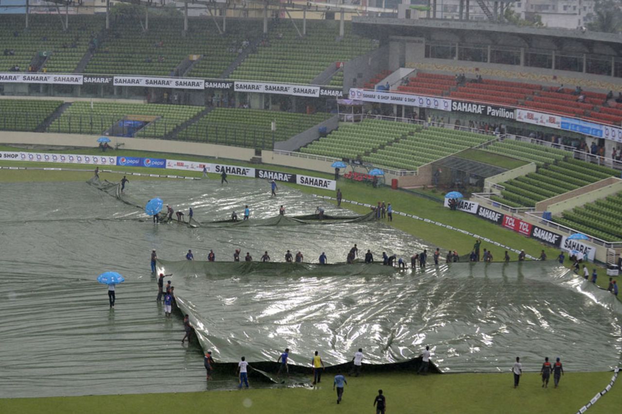 Ground staff cover the outfield and the pitch during a rain interruption, Bangladesh v India, 2nd ODI, Mirpur, June 17, 2014