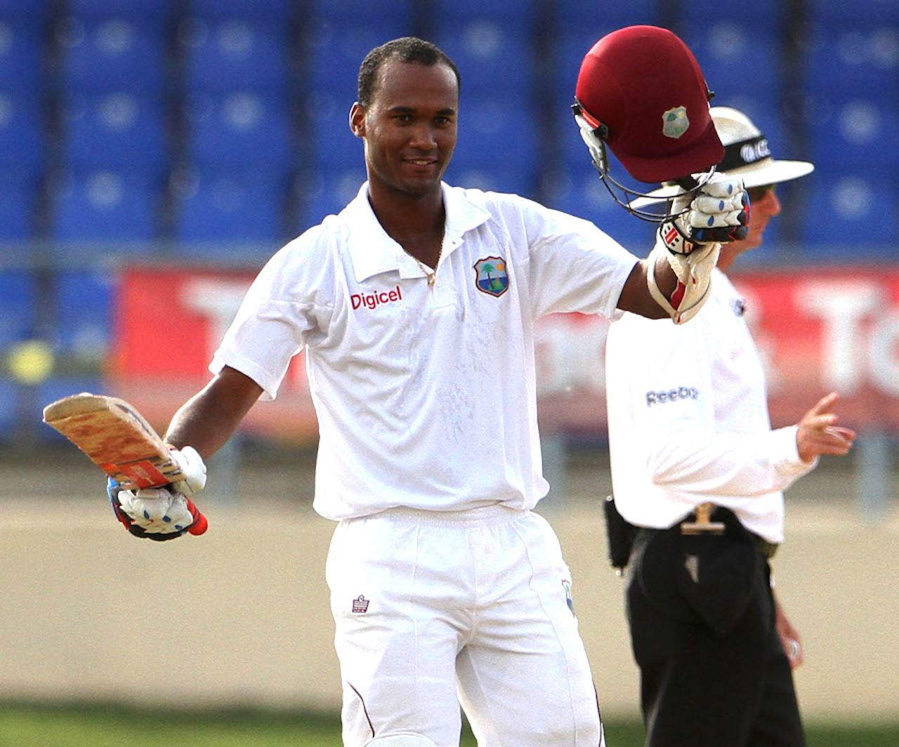 Kraigg Brathwaite raises his bat on reaching his first century, West Indies v New Zealand, 2nd Test, Trinidad, 2nd day, June 17, 2014