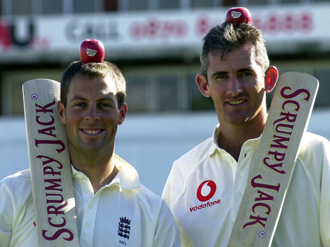 Marcus Trescothick and Andrew Caddick balance apples on their heads during a promotional event, Old Trafford, May 29, 2001