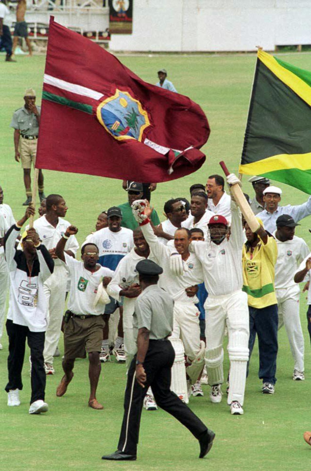 West Indies captain Jimmy Adams and Courtney Walsh run off the field after beating Pakistan by one wicket on the fifth day of the third and final Test match 29 May 2000 at the Antigua. Pakistan in West Indies 1999/00, 3rd Test, West Indies v Pakistan, Antigua Recreation Ground, St John's, Antigua, (25-29 May 2000) Day 5