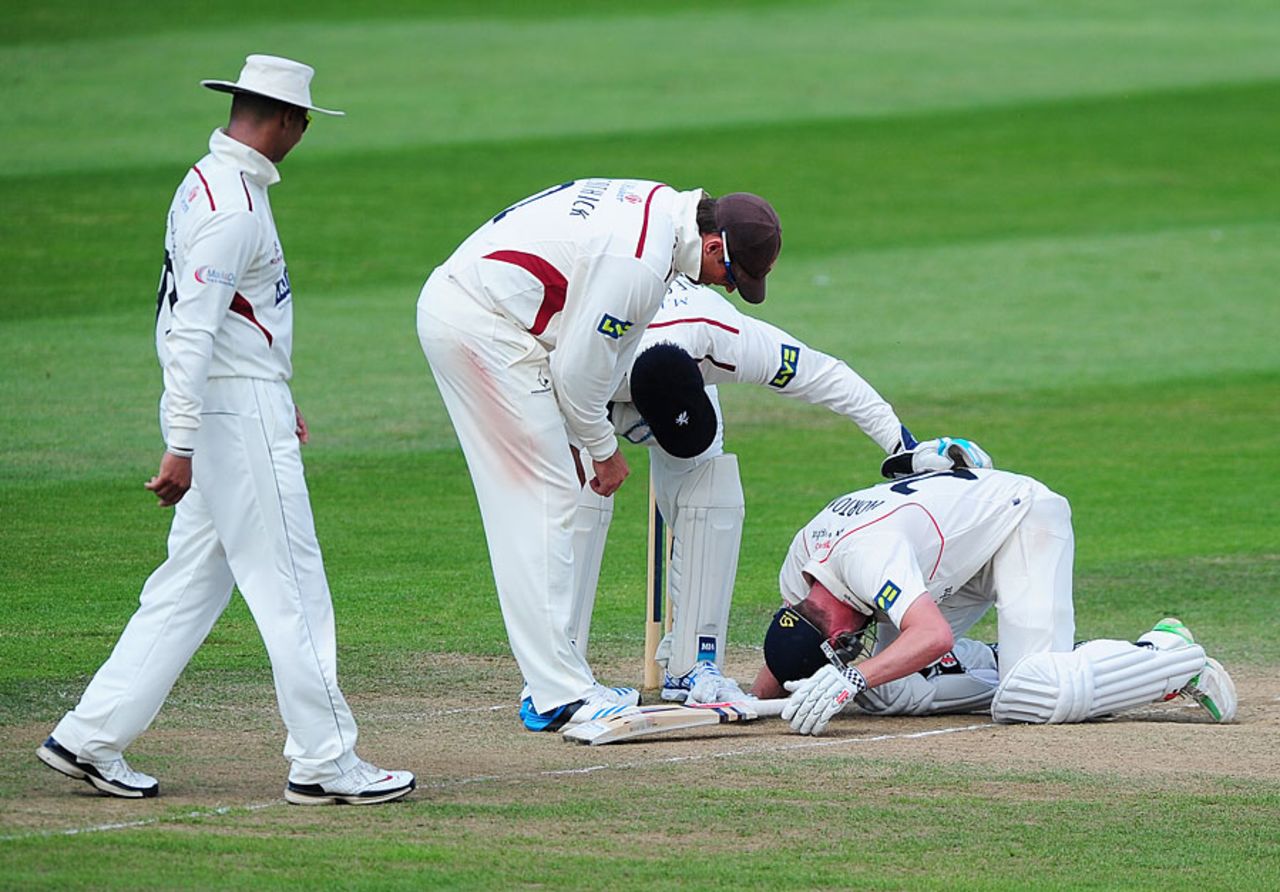 Somerset players show their concern for Paul Horton after a blow which forced him to retire hurt, Somerset v Lancashire, County Championship, Division One, Taunton, 3rd day, June 30, 2014