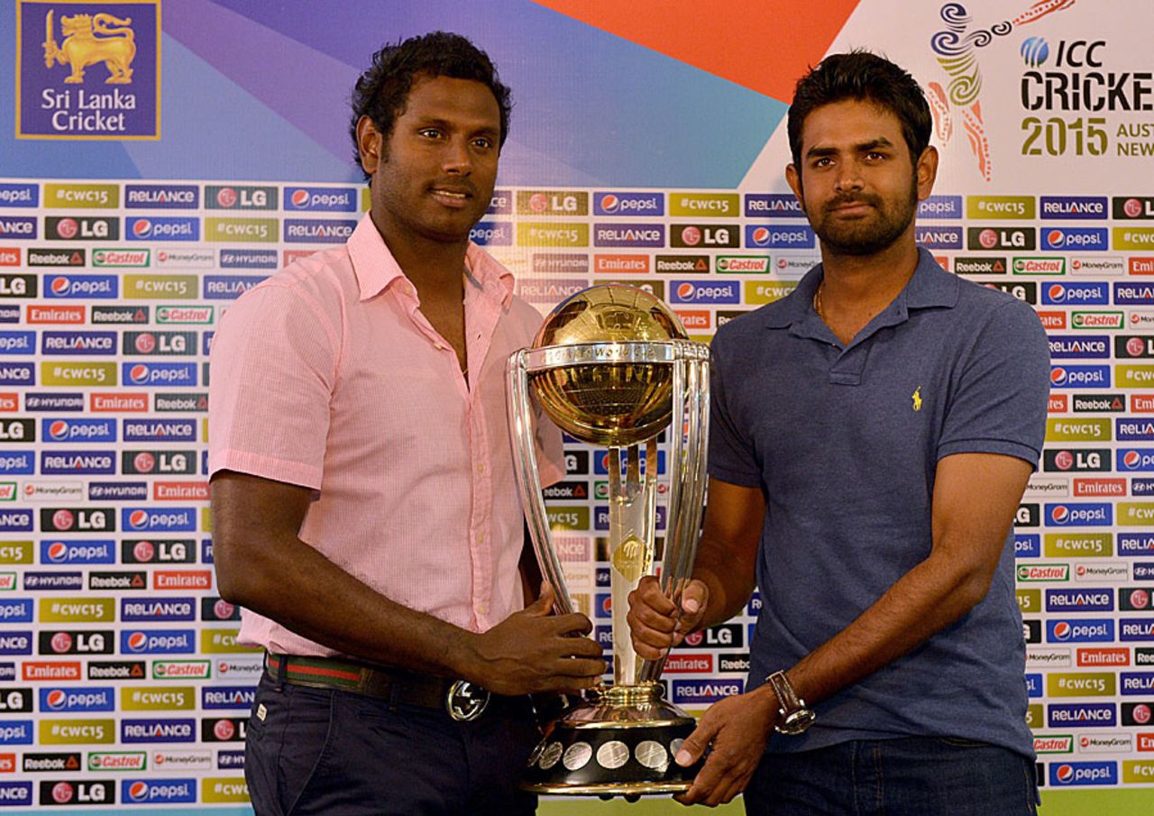 Angelo Mathews and Lahiru Thirimanne pose with the 2015 World Cup trophy, Colombo, July 4, 2014