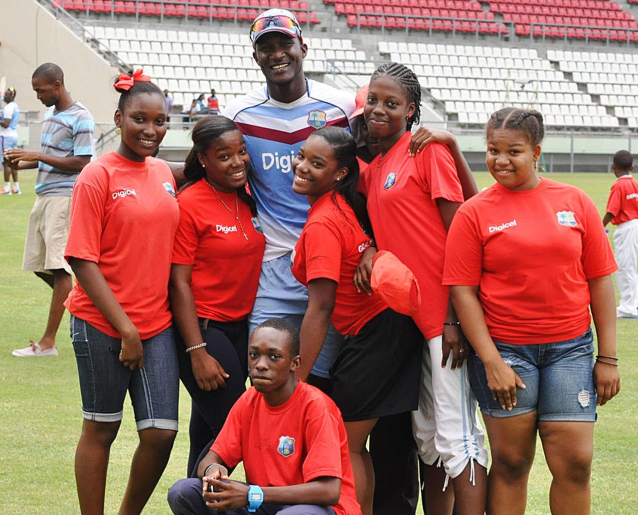 Young fans pose with Darren Sammy on the sidelines of a training session, Roseau, July 3, 2014 
