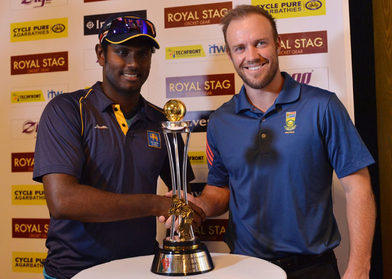 Angelo Mathews and AB de Villiers pose with the series trophy, Colombo, July 4, 2014