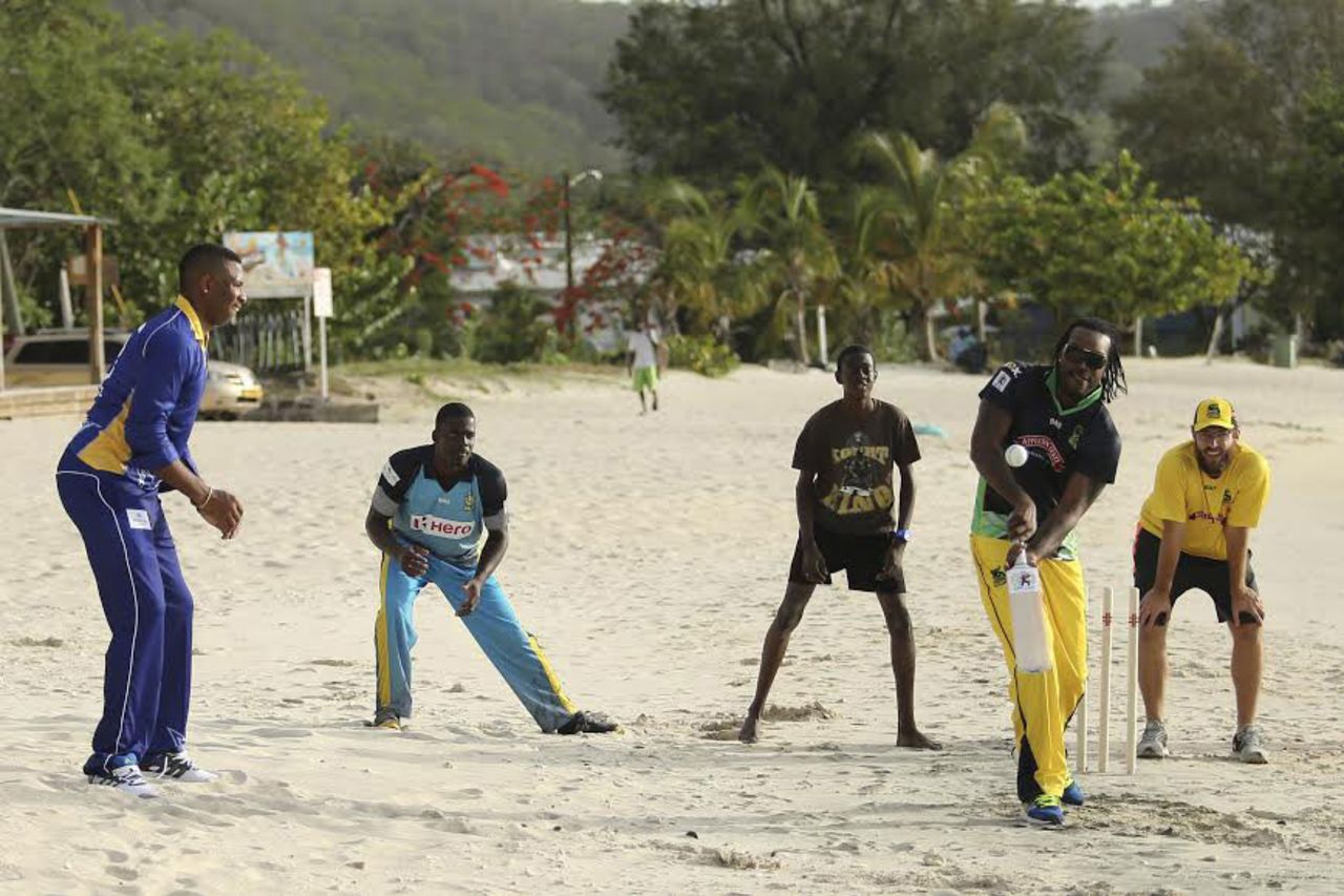 Kieron Pollard, Andre Fletcher, Chris Gayle and Daniel Vettori indulge in a game of beach cricket, Grenada, July 10, 2014