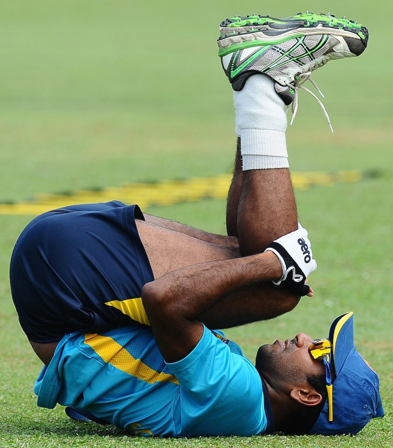Dhammika Prasad stretches during a practice session, Galle, July 15, 2014