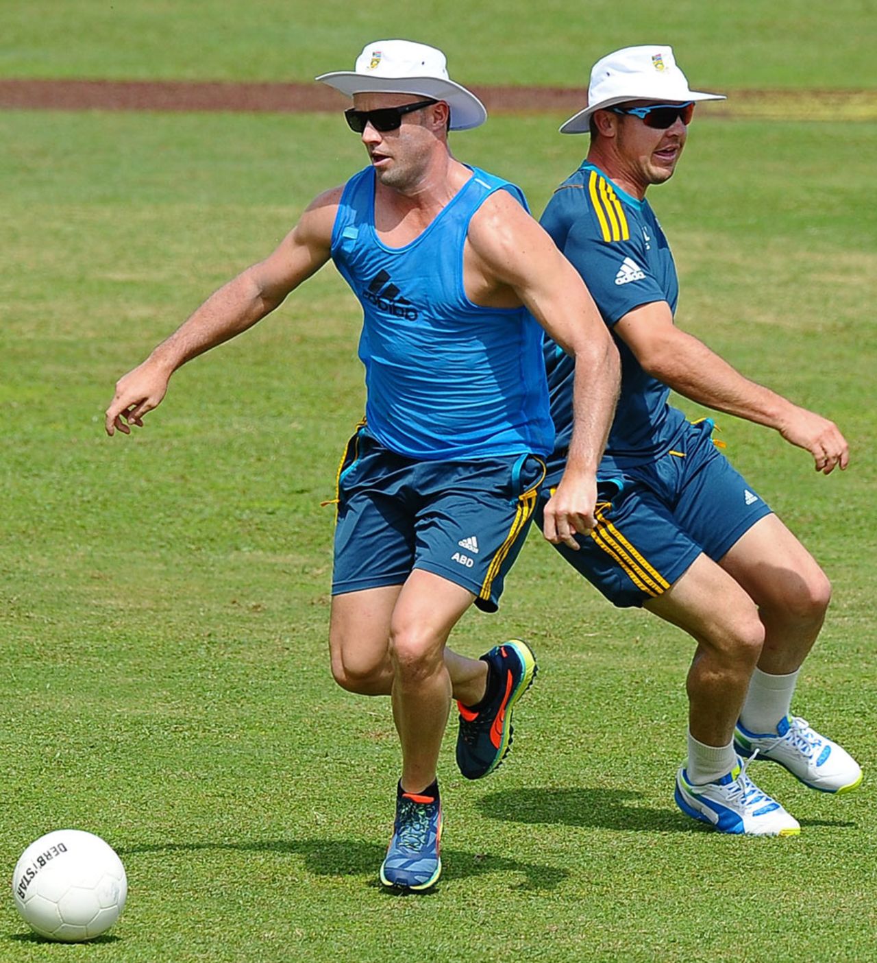 Dean Elgar and AB de Villiers kick about a football during training, Galle, July 15, 2014