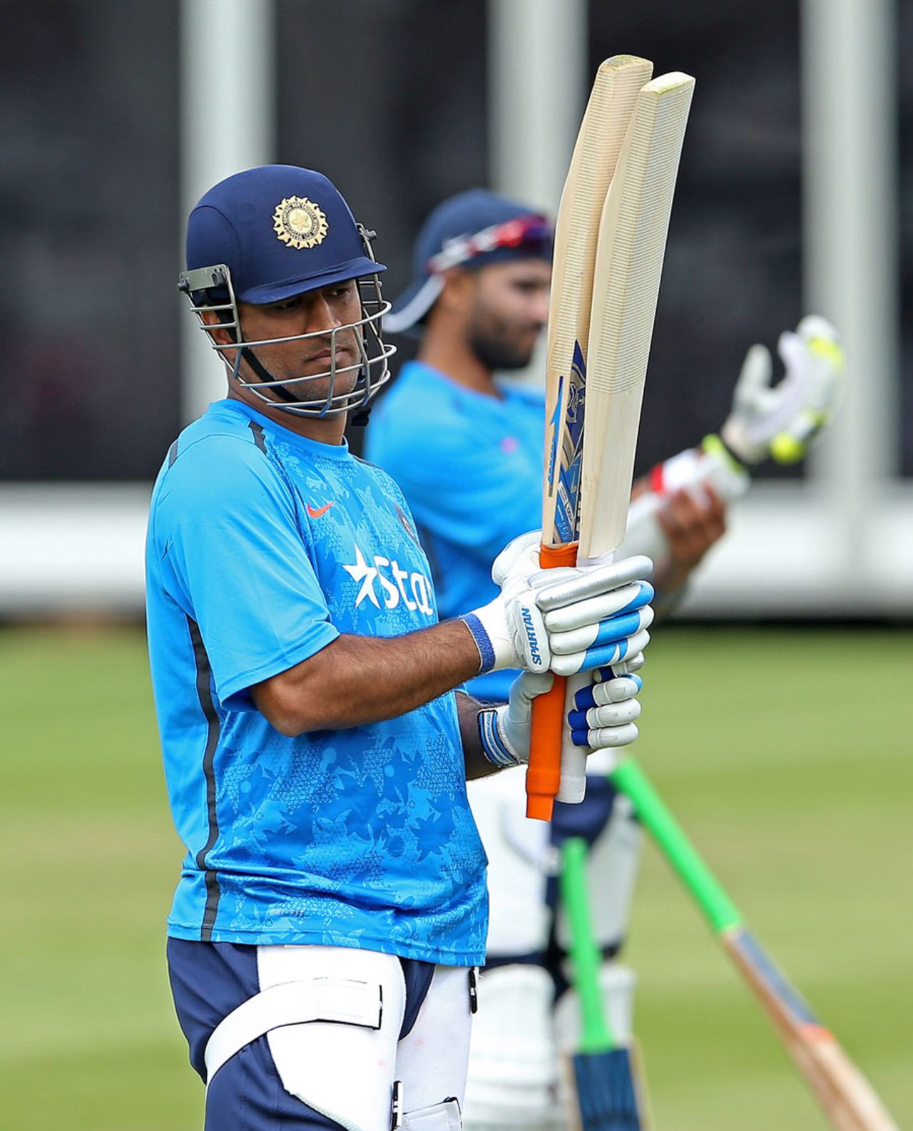 MS Dhoni examines his bat during a nets session, Lord's, July 15, 2014